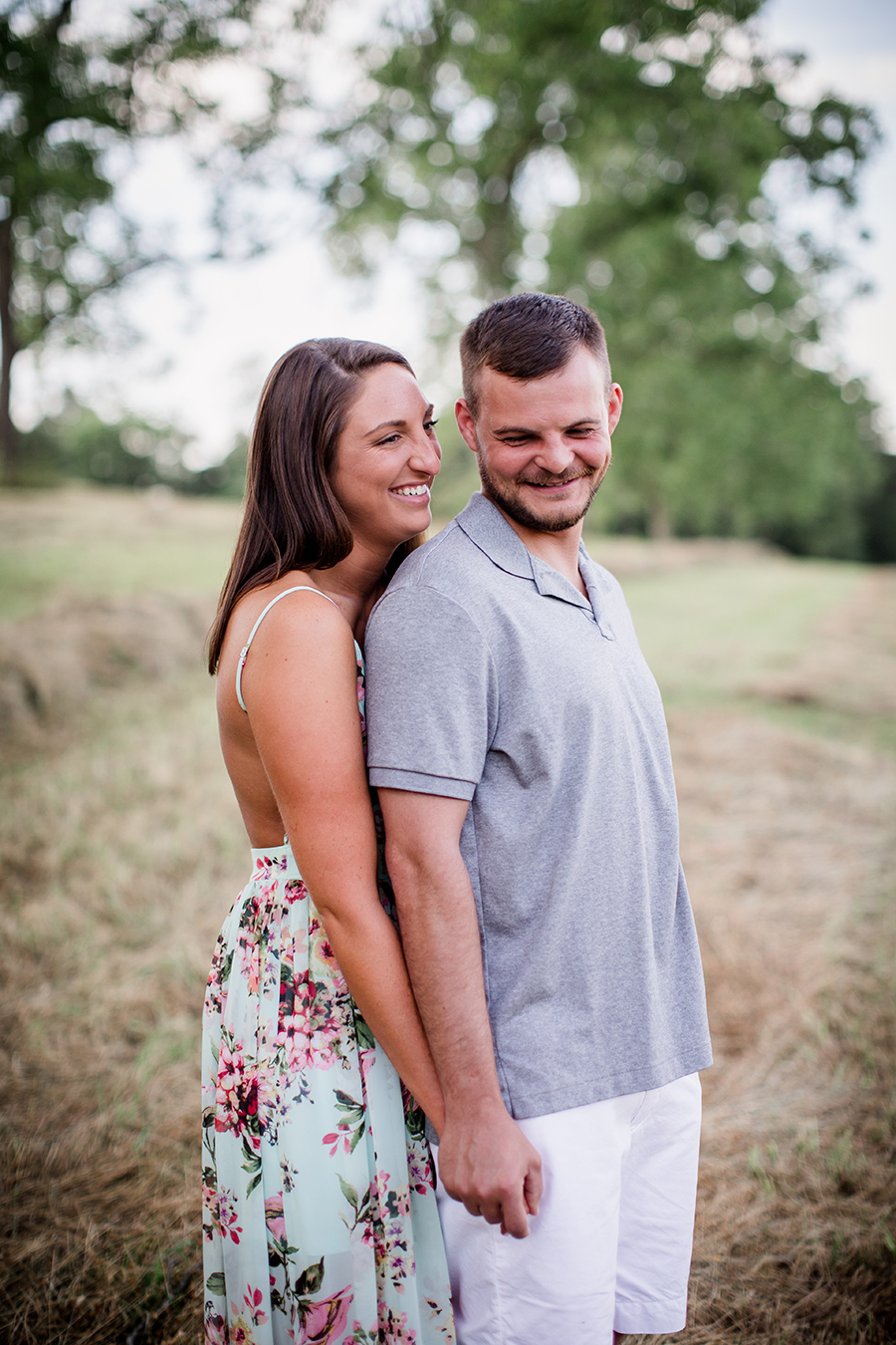 Holding hands from behind laughing at this Estate of Grace engagement session by Knoxville Wedding Photographer, Amanda May Photos.