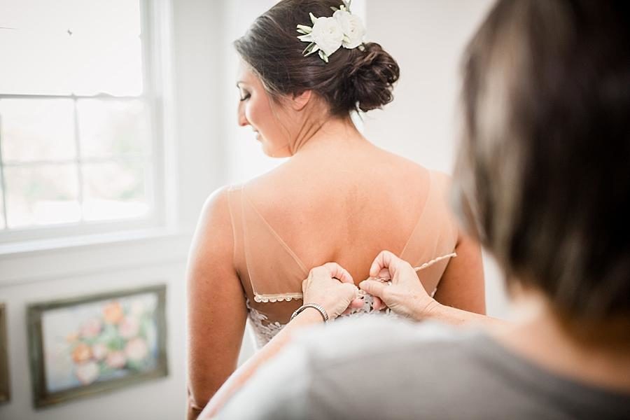 Hooking the dress at this Estate of Grace Wedding by Knoxville Wedding Photographer, Amanda May Photos.