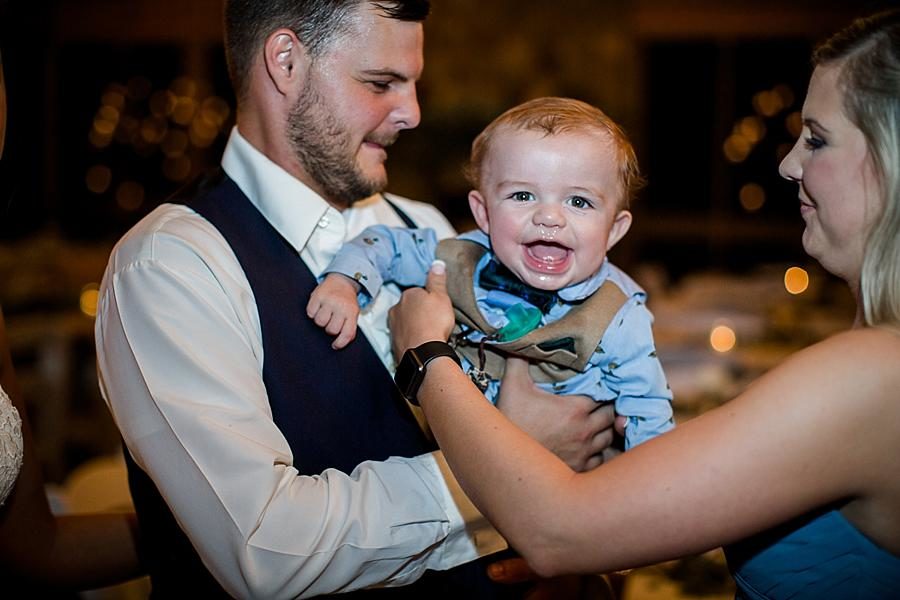 Holding a baby at this Estate of Grace Wedding by Knoxville Wedding Photographer, Amanda May Photos.