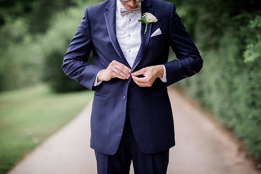 Buttoning the jacket at this Cheval Manor Wedding by Knoxville Wedding Photographer, Amanda May Photos.