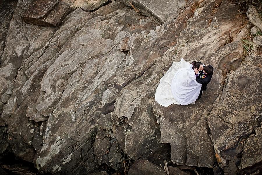 Looking down on bride and groom on the rocks at this Cumberland Mountain State Park wedding by Knoxville Wedding Photographer, Amanda May Photos.
