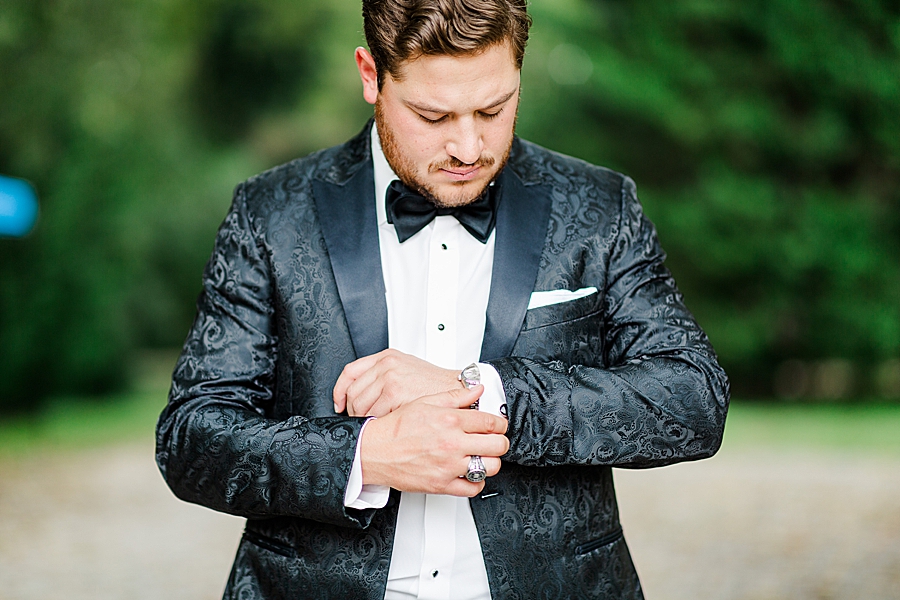 groom fixing sleeves at this kincaid house wedding