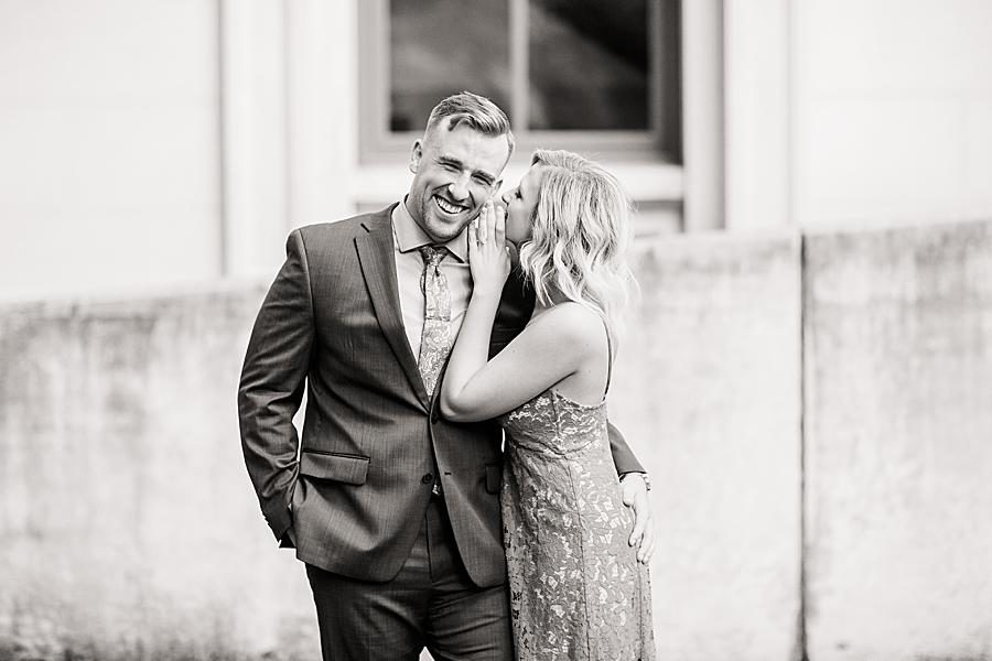 Whispering in ear at this Knoxville Botanical Gardens engagement by Knoxville Wedding Photographer, Amanda May Photos.