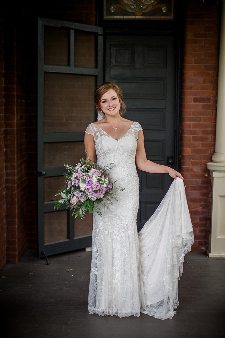 Bride holding dress at this Historic Westwood Bridal session by Knoxville Wedding Photographer, Amanda May Photos.