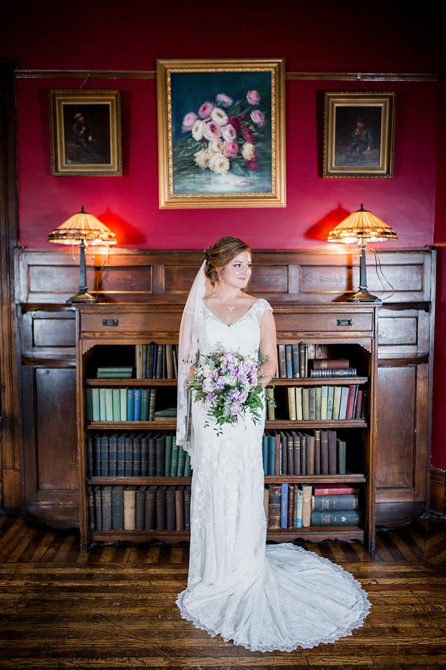 Bride standing in front of bookcase at this Historic Westwood Bridal session by Knoxville Wedding Photographer, Amanda May Photos.