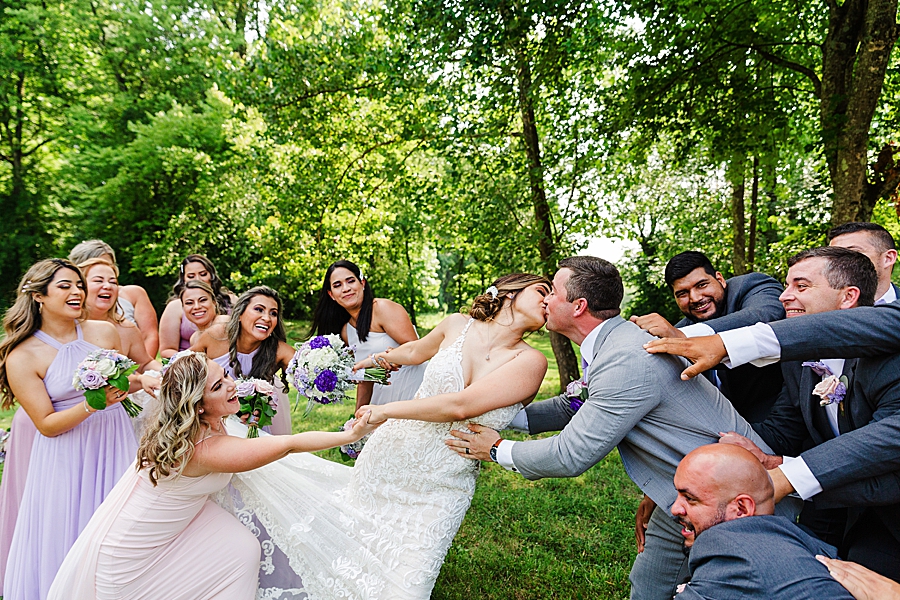 bridal party pulling apart couple at this lighthouse knoxville wedding