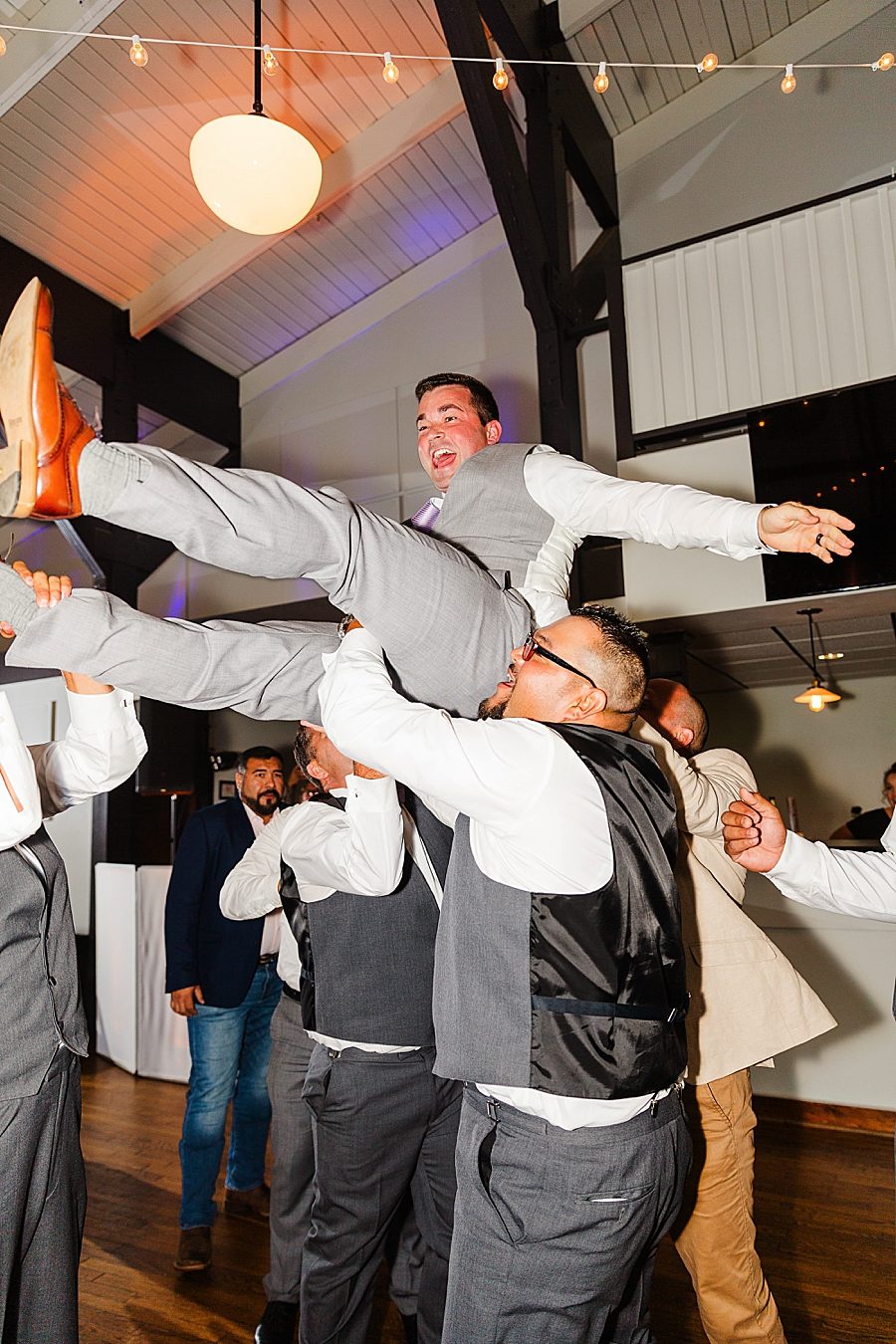 groomsmen holding groom at this lighthouse knoxville wedding