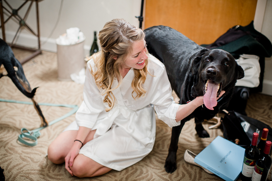 Bride petting her puppy during this getting ready picture at this winter wedding at Knoxville Wedding Venue, Jackson Terminal, by Knoxville Wedding Photographer, Amanda May Photos.