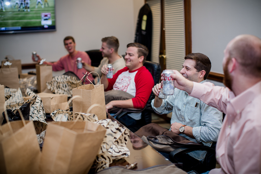 Groomsmen opening their gifts during this getting ready picture at this winter wedding at Knoxville Wedding Venue, Jackson Terminal, by Knoxville Wedding Photographer, Amanda May Photos.