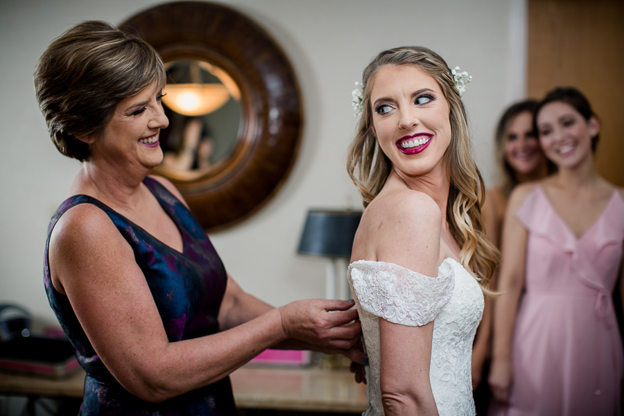 Mom zipping up the bride's dress during this getting ready picture at this winter wedding at Knoxville Wedding Venue, Jackson Terminal, by Knoxville Wedding Photographer, Amanda May Photos.