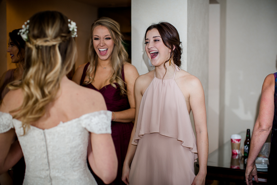 Bridesmaids looking at the bride for the first time during this getting ready picture at this winter wedding at Knoxville Wedding Venue, Jackson Terminal, by Knoxville Wedding Photographer, Amanda May Photos.