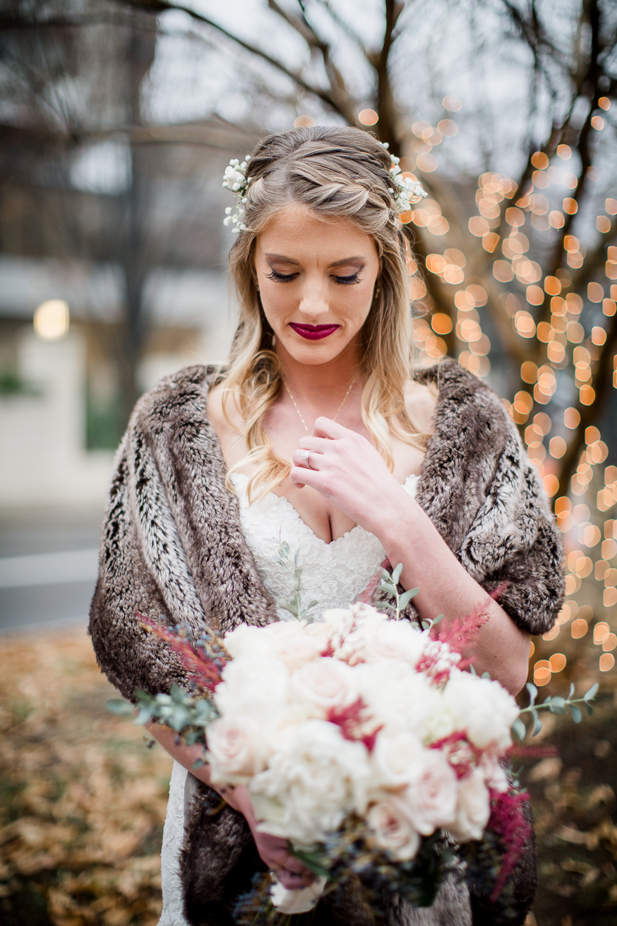 Holding onto a locket her parents gave her during the bride and bridesmaids pictures at this winter wedding at Knoxville Wedding Venue, Jackson Terminal, by Knoxville Wedding Photographer, Amanda May Photos.