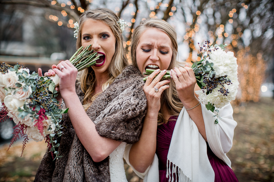 Eating their bouquet stems during the bride and bridesmaids pictures at this winter wedding at Knoxville Wedding Venue, Jackson Terminal, by Knoxville Wedding Photographer, Amanda May Photos.