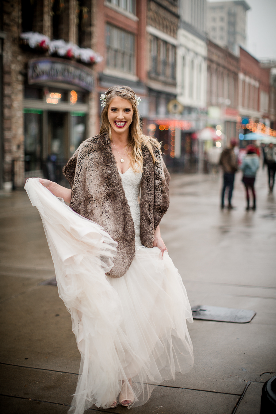 Bride twirling in her dress during the bride and bridesmaids pictures at this winter wedding at Knoxville Wedding Venue, Jackson Terminal, by Knoxville Wedding Photographer, Amanda May Photos.