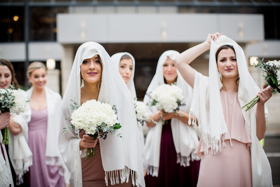 Scarf on their heads during the bride and bridesmaids pictures at this winter wedding at Knoxville Wedding Venue, Jackson Terminal, by Knoxville Wedding Photographer, Amanda May Photos.