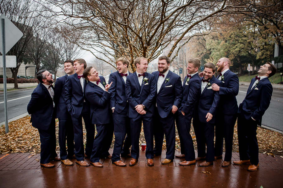 Hanging out together during the groom and groomsmen pictures at this winter wedding at Knoxville Wedding Venue, Jackson Terminal, by Knoxville Wedding Photographer, Amanda May Photos.