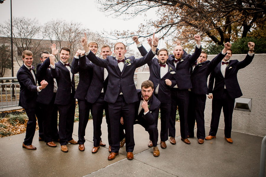 Flying V with major excitement during the groom and groomsmen pictures at this winter wedding at Knoxville Wedding Venue, Jackson Terminal, by Knoxville Wedding Photographer, Amanda May Photos.
