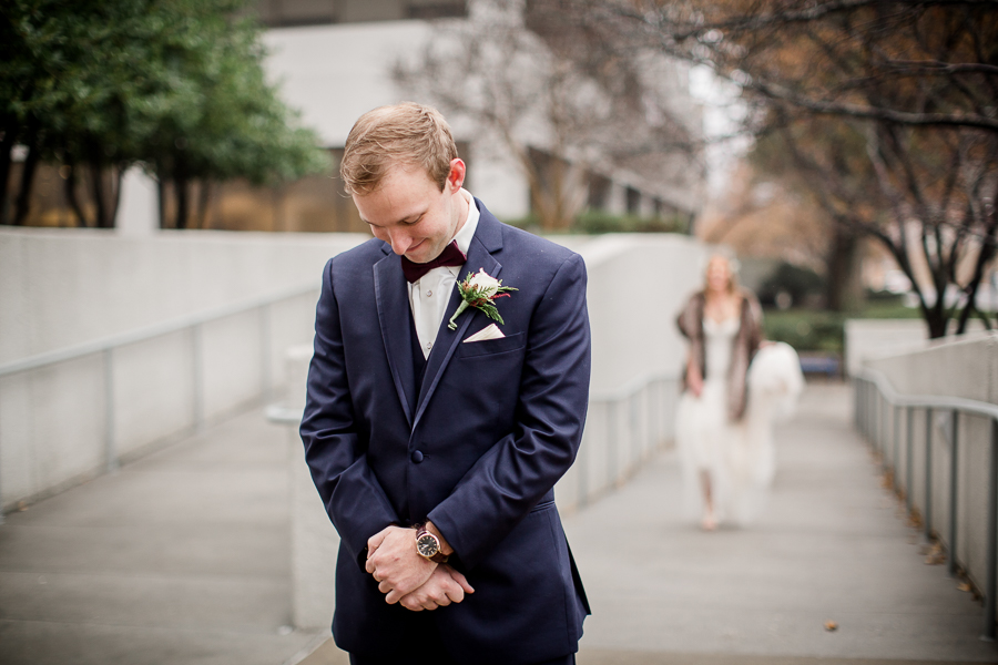Groom waiting on his bride during the first look pictures at this winter wedding at Knoxville Wedding Venue, Jackson Terminal, by Knoxville Wedding Photographer, Amanda May Photos.