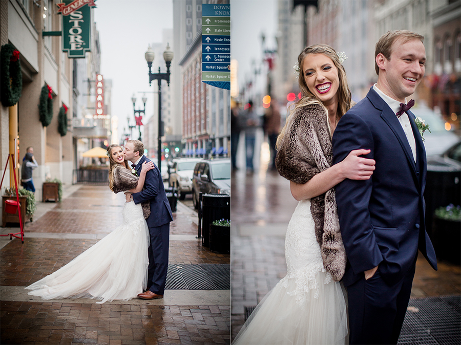 The bride hugging the groom from behind during the bride and groom romantic portraits at this winter wedding at Knoxville Wedding Venue, Jackson Terminal, by Knoxville Wedding Photographer, Amanda May Photos.