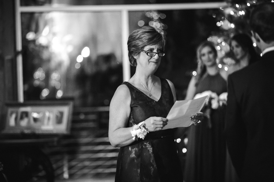 Mother of the bride has a reading during the ceremony pictures at this winter wedding at Knoxville Wedding Venue, Jackson Terminal, by Knoxville Wedding Photographer, Amanda May Photos.