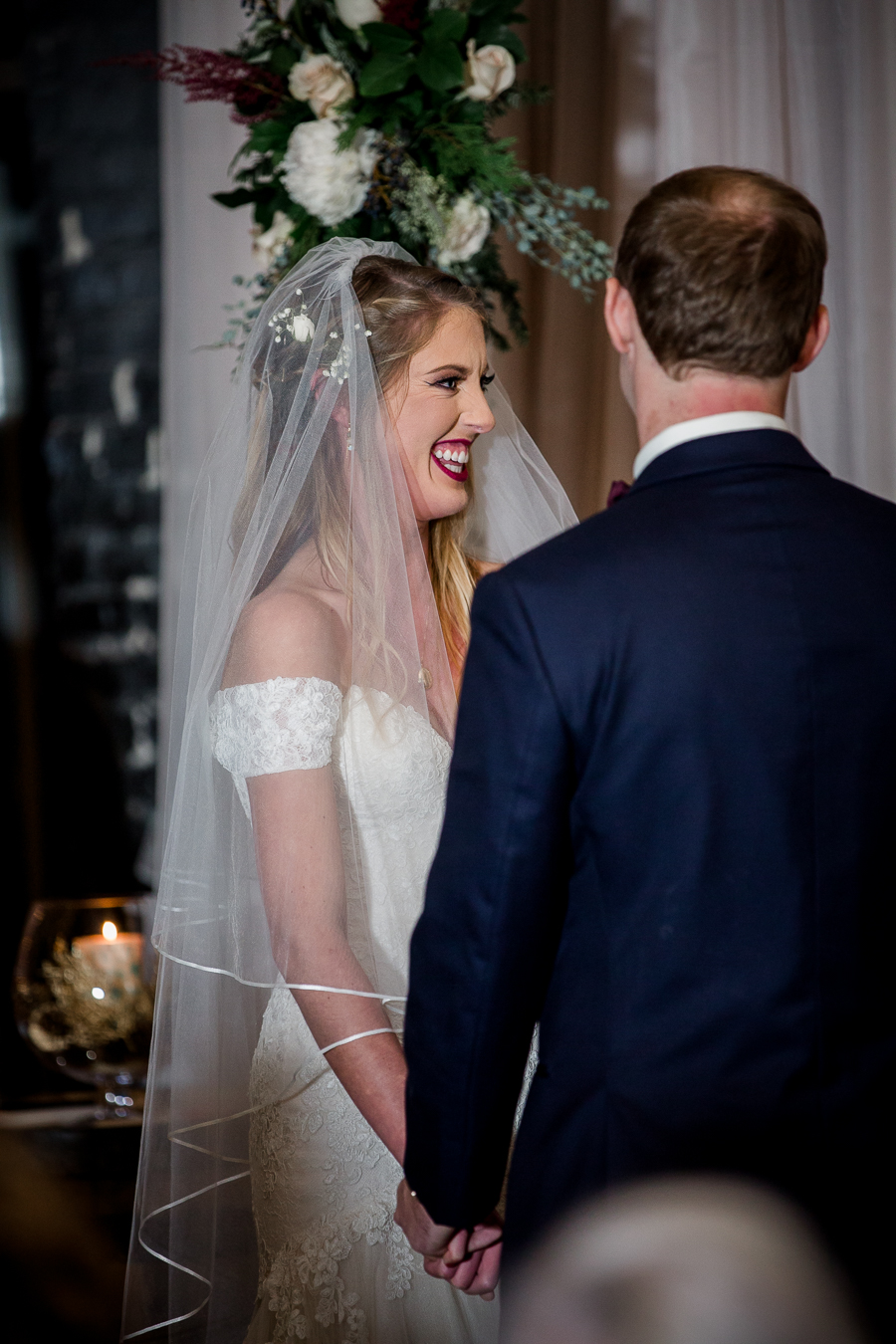 Bride laughs hard during the ceremony pictures at this winter wedding at Knoxville Wedding Venue, Jackson Terminal, by Knoxville Wedding Photographer, Amanda May Photos.