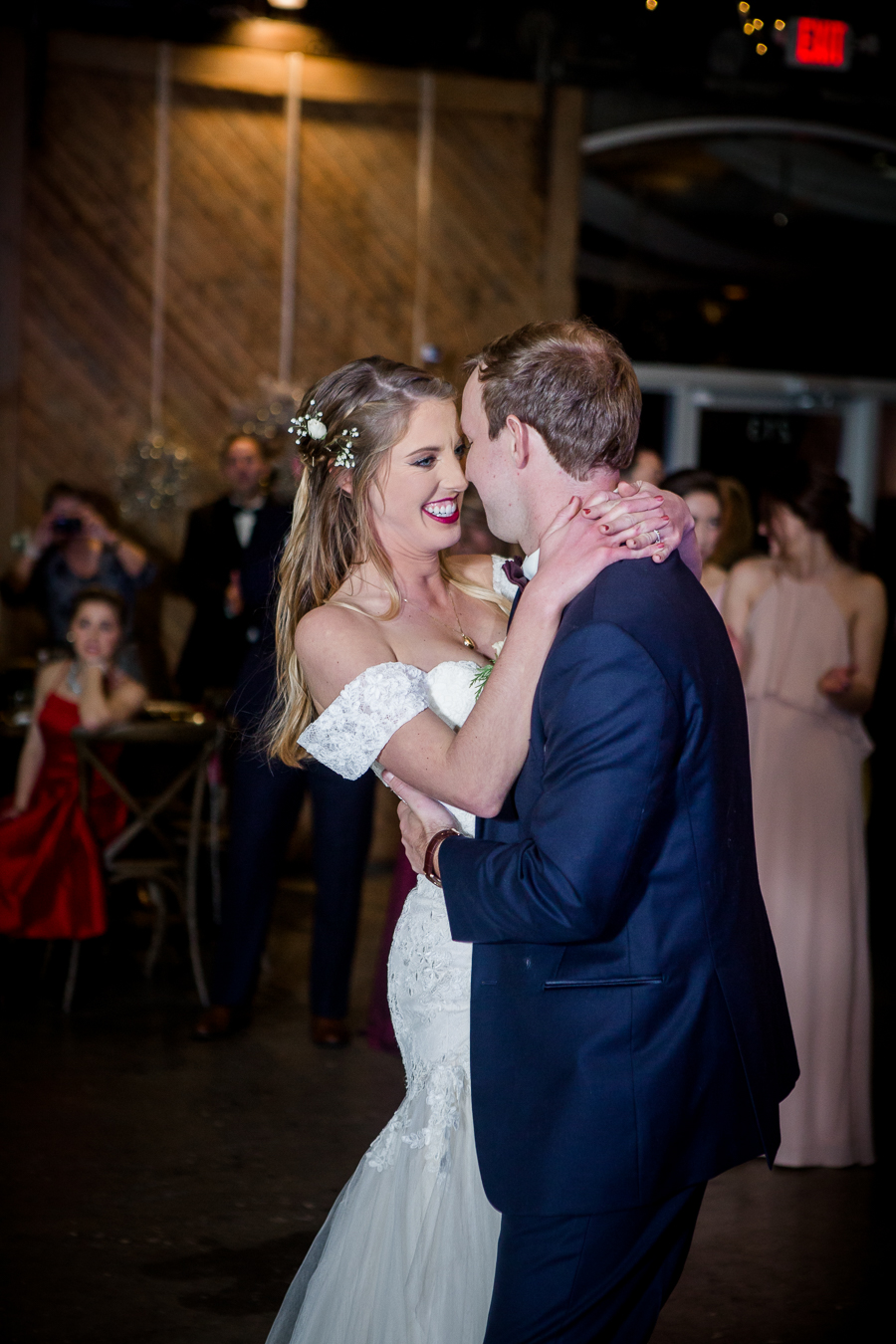 Her hands wrapped around his neck during the first dance during the reception pictures at this winter wedding at Knoxville Wedding Venue, Jackson Terminal, by Knoxville Wedding Photographer, Amanda May Photos.