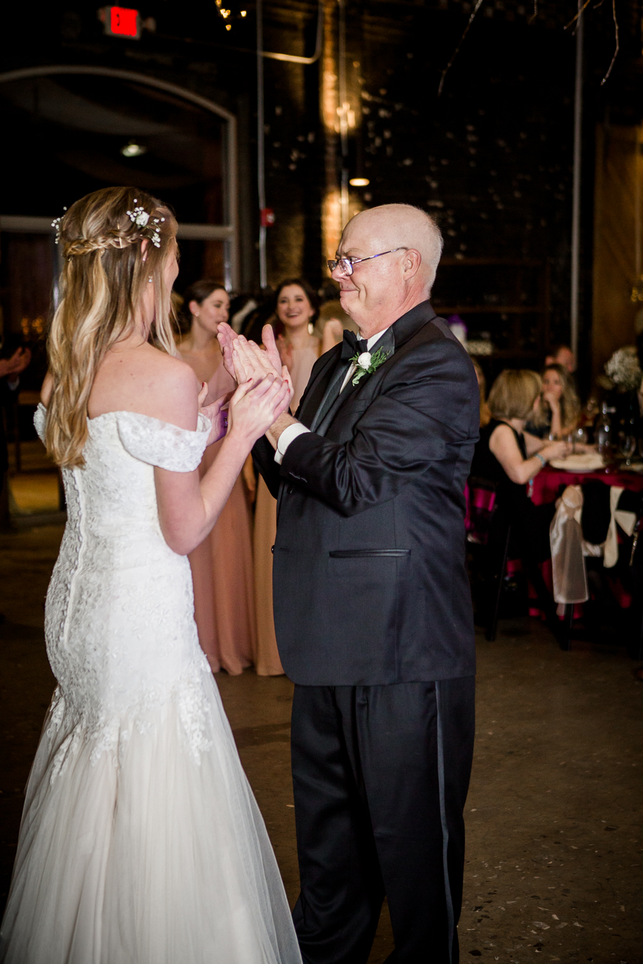 Father of the bride claps for the bride during the reception pictures at this winter wedding at Knoxville Wedding Venue, Jackson Terminal, by Knoxville Wedding Photographer, Amanda May Photos.
