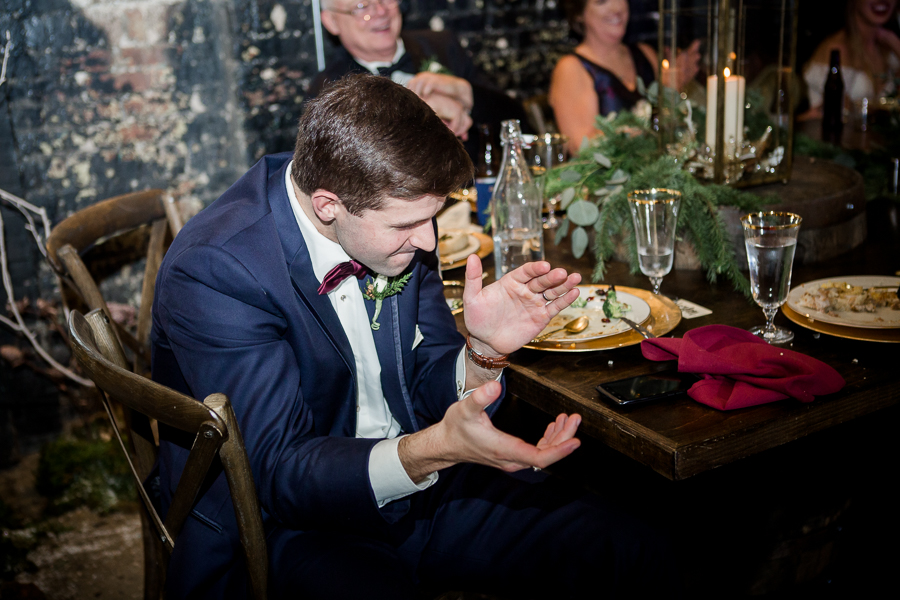 Brother-n-law claps during toasts during the reception pictures at this winter wedding at Knoxville Wedding Venue, Jackson Terminal, by Knoxville Wedding Photographer, Amanda May Photos.