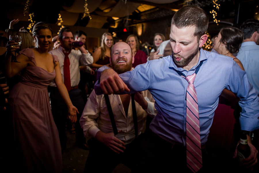 Funny face during the dancing reception pictures at this winter wedding at Knoxville Wedding Venue, Jackson Terminal, by Knoxville Wedding Photographer, Amanda May Photos.