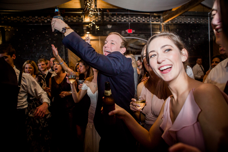 Groom's hands raised during the dancing reception pictures at this winter wedding at Knoxville Wedding Venue, Jackson Terminal, by Knoxville Wedding Photographer, Amanda May Photos.