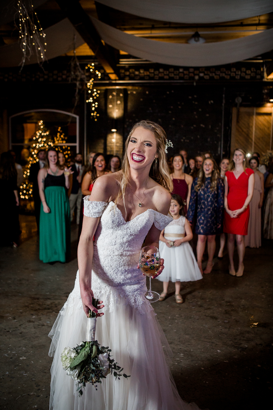 Bouquet toss during the reception pictures at this winter wedding at Knoxville Wedding Venue, Jackson Terminal, by Knoxville Wedding Photographer, Amanda May Photos.