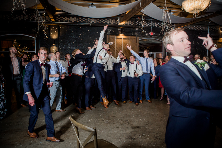 Garter toss during the reception pictures at this winter wedding at Knoxville Wedding Venue, Jackson Terminal, by Knoxville Wedding Photographer, Amanda May Photos.