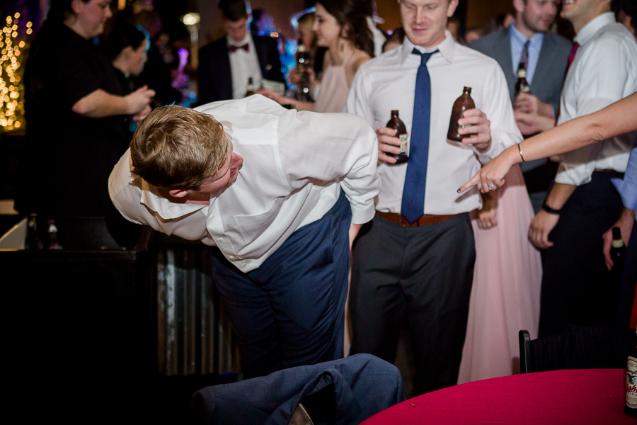 Guy ripped his pants during the dancing reception pictures at this winter wedding at Knoxville Wedding Venue, Jackson Terminal, by Knoxville Wedding Photographer, Amanda May Photos.
