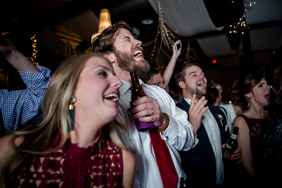 Crowd singing with the band during the dancing reception pictures at this winter wedding at Knoxville Wedding Venue, Jackson Terminal, by Knoxville Wedding Photographer, Amanda May Photos.