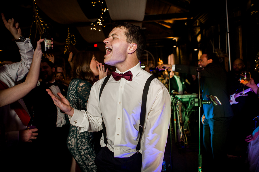 Guest singing loud during the dancing reception pictures at this winter wedding at Knoxville Wedding Venue, Jackson Terminal, by Knoxville Wedding Photographer, Amanda May Photos.