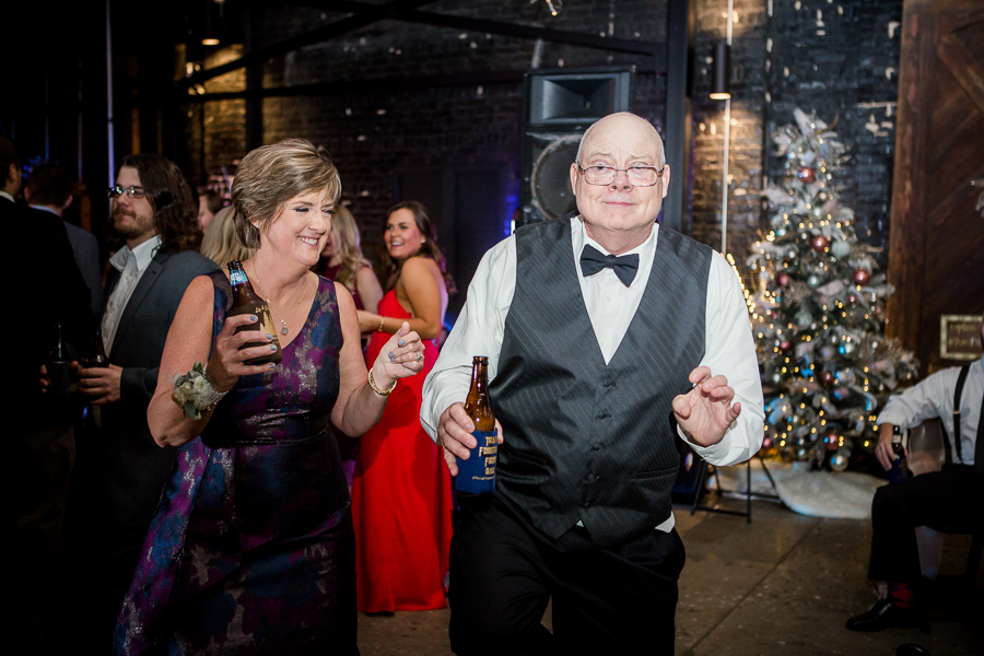 Parents of the bride dancing during the dancing reception pictures at this winter wedding at Knoxville Wedding Venue, Jackson Terminal, by Knoxville Wedding Photographer, Amanda May Photos.