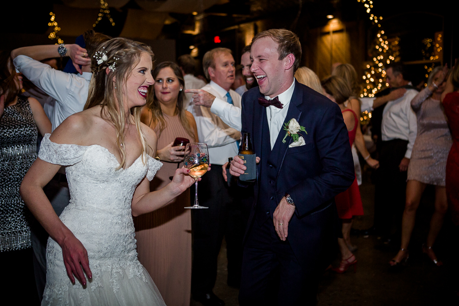 Bride and groom dancing together during the dancing reception pictures at this winter wedding at Knoxville Wedding Venue, Jackson Terminal, by Knoxville Wedding Photographer, Amanda May Photos.