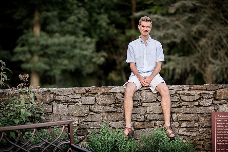 Sitting on the wall at this Knoxville Botanical Gardens Senior Session by Knoxville Wedding Photographer, Amanda May Photos.