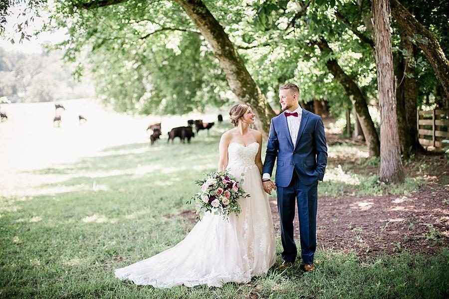 In a cow pasture at this RiverView Family Farm Wedding by Knoxville Wedding Photographer, Amanda May Photos.