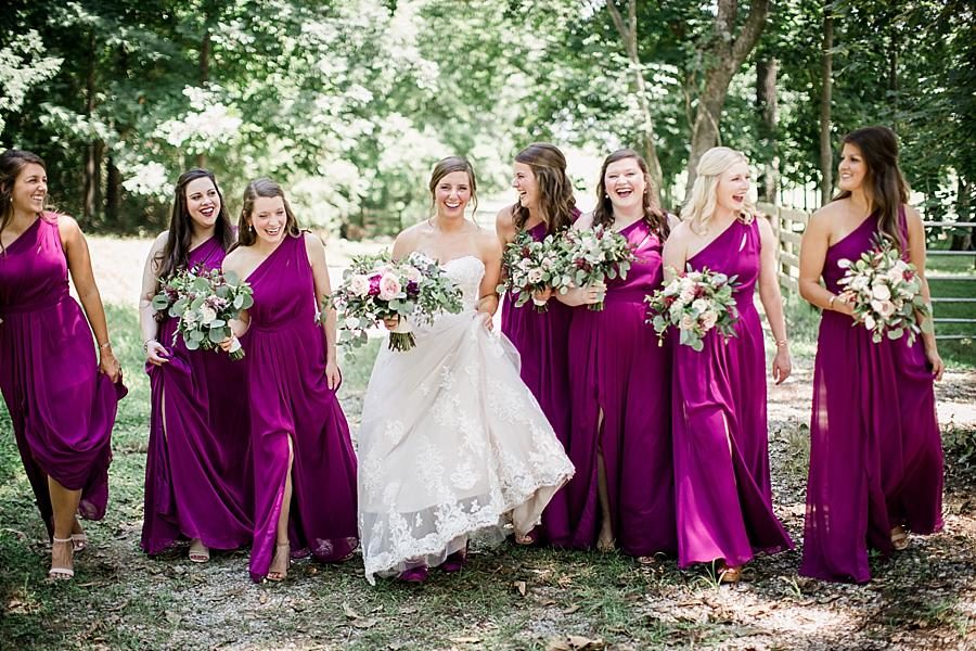 Bride walking with her bridesmaids at this RiverView Family Farm Wedding by Knoxville Wedding Photographer, Amanda May Photos.