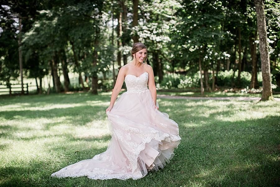 Twirling the dress at this RiverView Family Farm Wedding by Knoxville Wedding Photographer, Amanda May Photos.