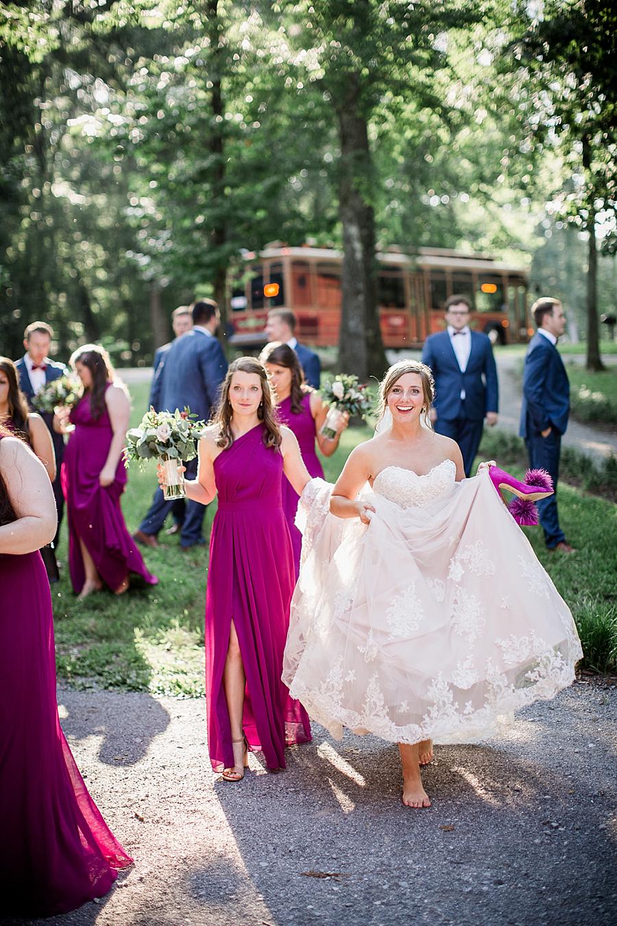 Carrying the dress at this RiverView Family Farm Wedding by Knoxville Wedding Photographer, Amanda May Photos.