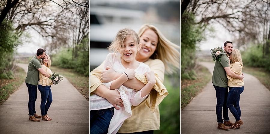 Hugging their little girl at this just married Volunteer Landing session by Knoxville Wedding Photographer, Amanda May Photos.