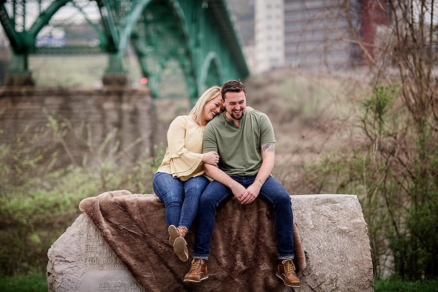 Sitting on a rock at this just married Volunteer Landing session by Knoxville Wedding Photographer, Amanda May Photos.