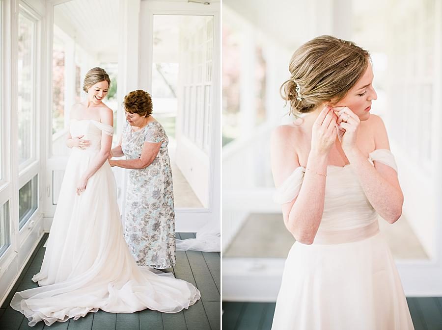 Buttoning the gown at this Marblegate Farm Wedding by Knoxville Wedding Photographer, Amanda May Photos.