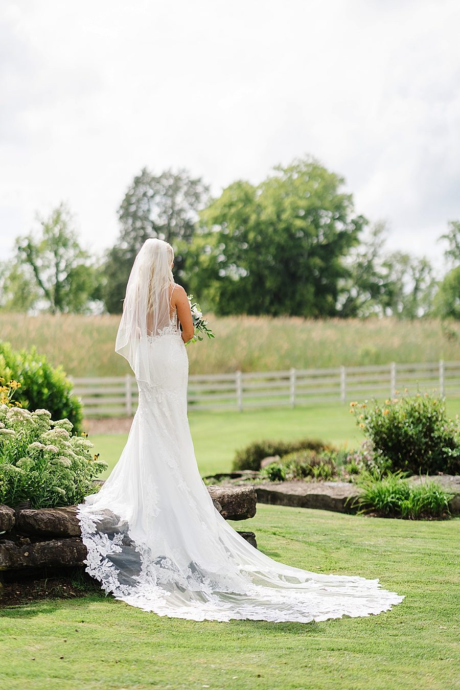 bride with long train at this marblegate farm wedding