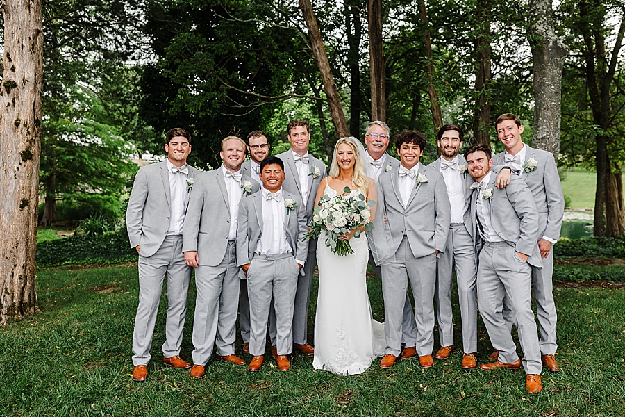 bride and groomsmen at this marblegate farm wedding