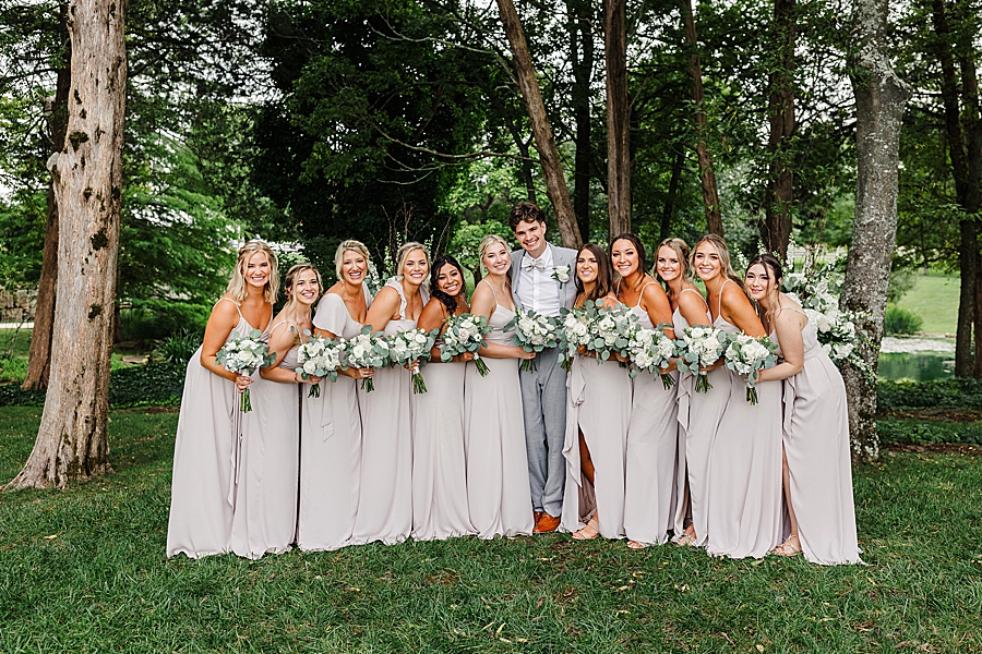 groom and bridesmaids at this marblegate farm wedding