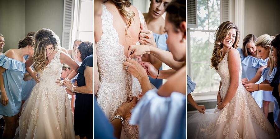 Getting into the brides dress at this East Ivy Mansion Wedding session by Knoxville Wedding Photographer, Amanda May Photos.
