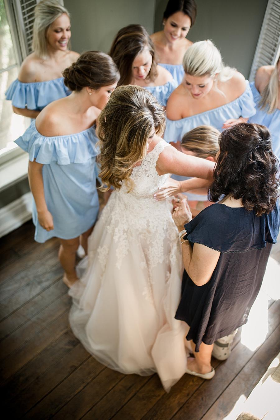 Overshot of bride getting into dress at this East Ivy Mansion Wedding session by Knoxville Wedding Photographer, Amanda May Photos.